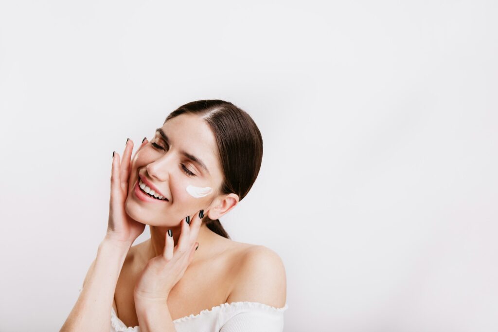 Woman smiling after her skincare routine